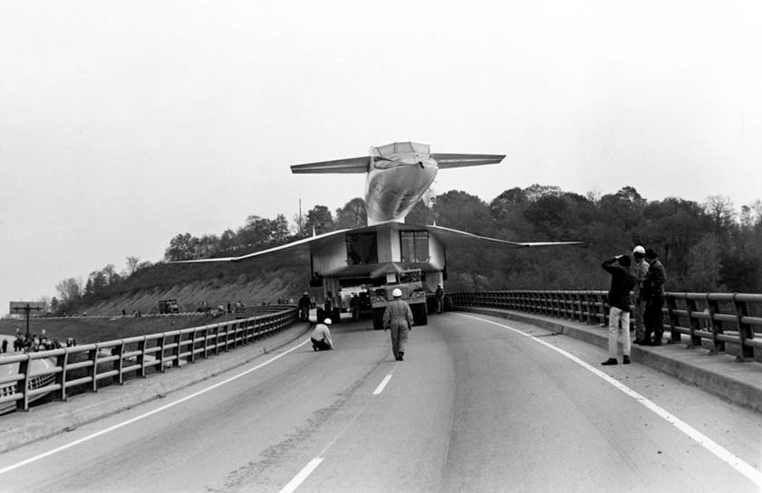 picture of aircraft being towed down highway